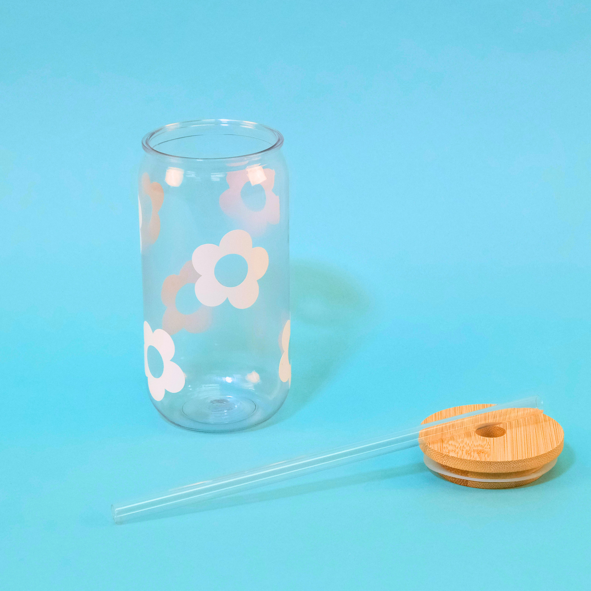 Daisy Tumbler with Bamboo lid and straw laying beside